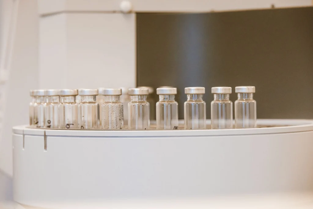 Row of laboratory flasks containing research compounds on a bench