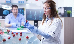 Two researchers reviewing laboratory equipment and samples, representing UK regulation and compliance research articles